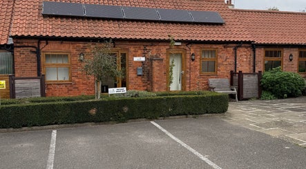 Charming brick facade of Beauty by Tracy Polak in Eakring, England, GB welcoming guests.