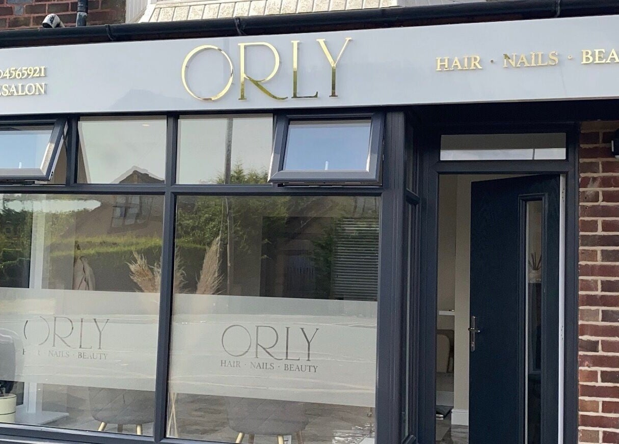 Front exterior of Orly salon in Southport, England, GB showcasing its elegant signage and large windows.