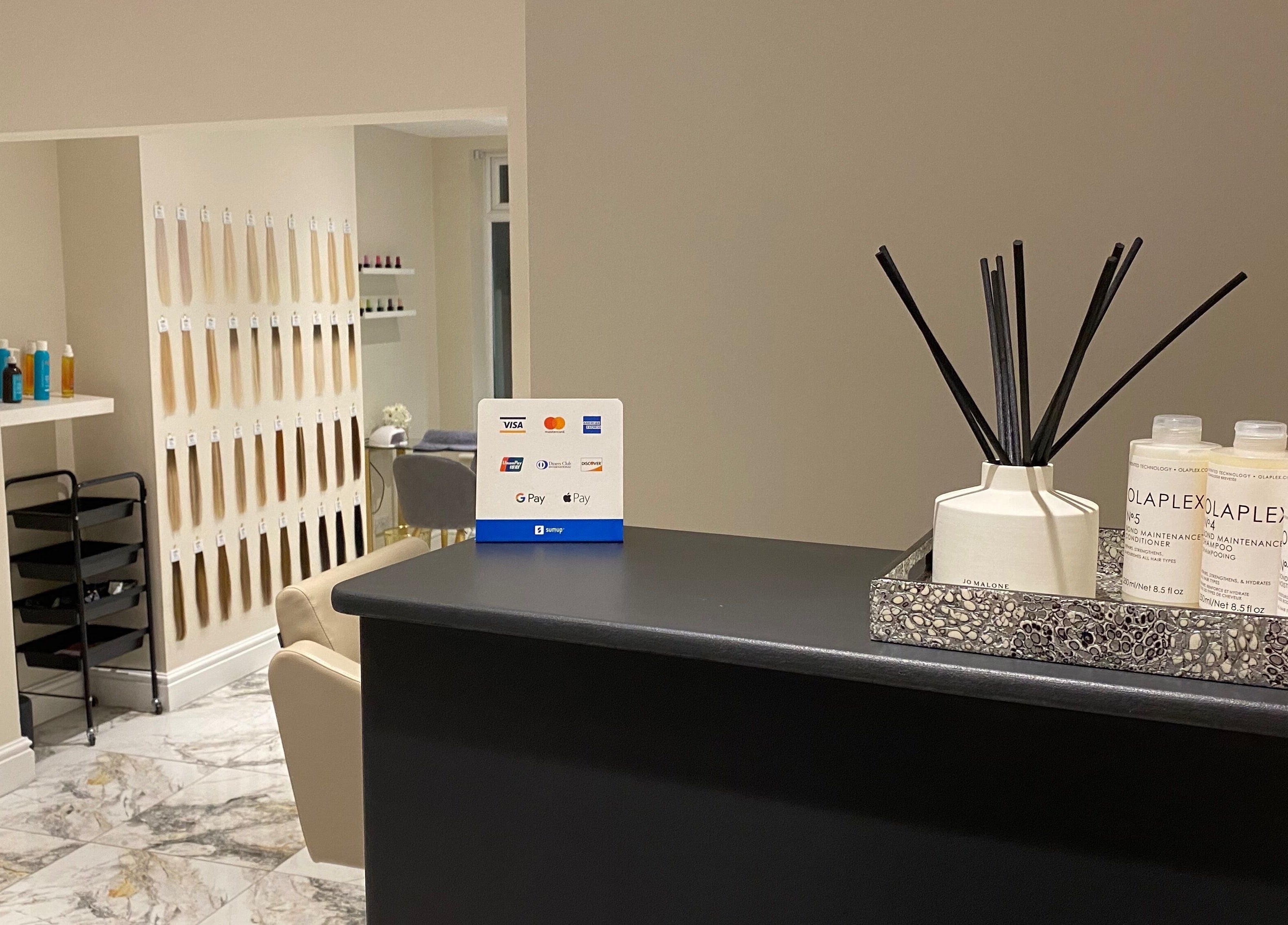 Reception area of Orly in Southport, England, GB with elegant decor and beauty products.