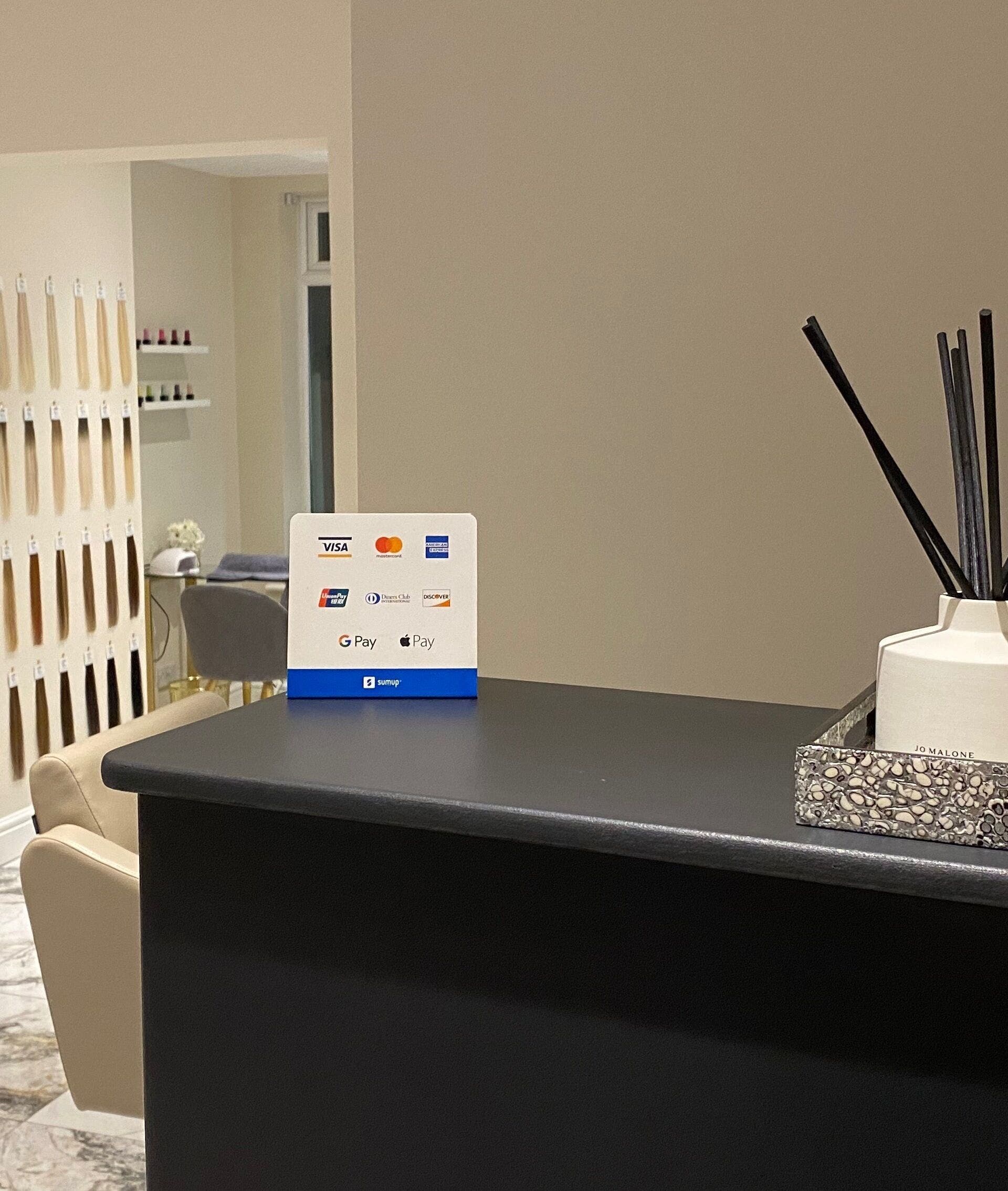 Reception area of Orly in Southport, England, GB with elegant decor and beauty products.