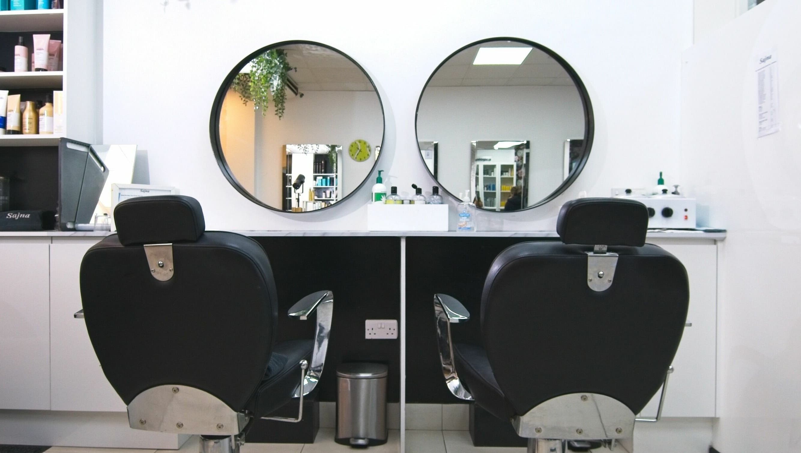 Elegant salon chairs and mirrors at Sajna Hair & Beauty, Wimbledon, London, England, GB.