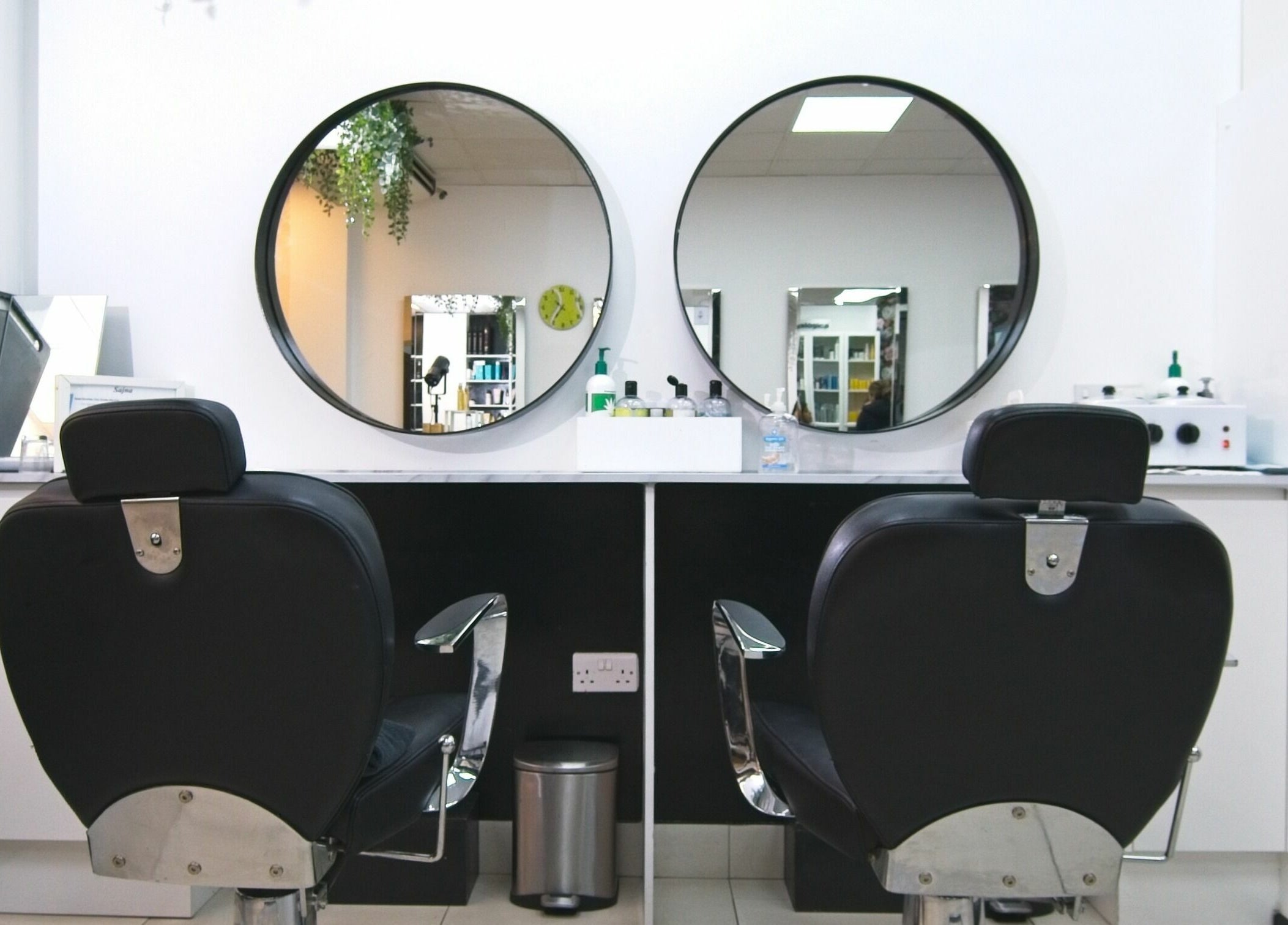 Elegant salon chairs and mirrors at Sajna Hair & Beauty, Wimbledon, London, England, GB.