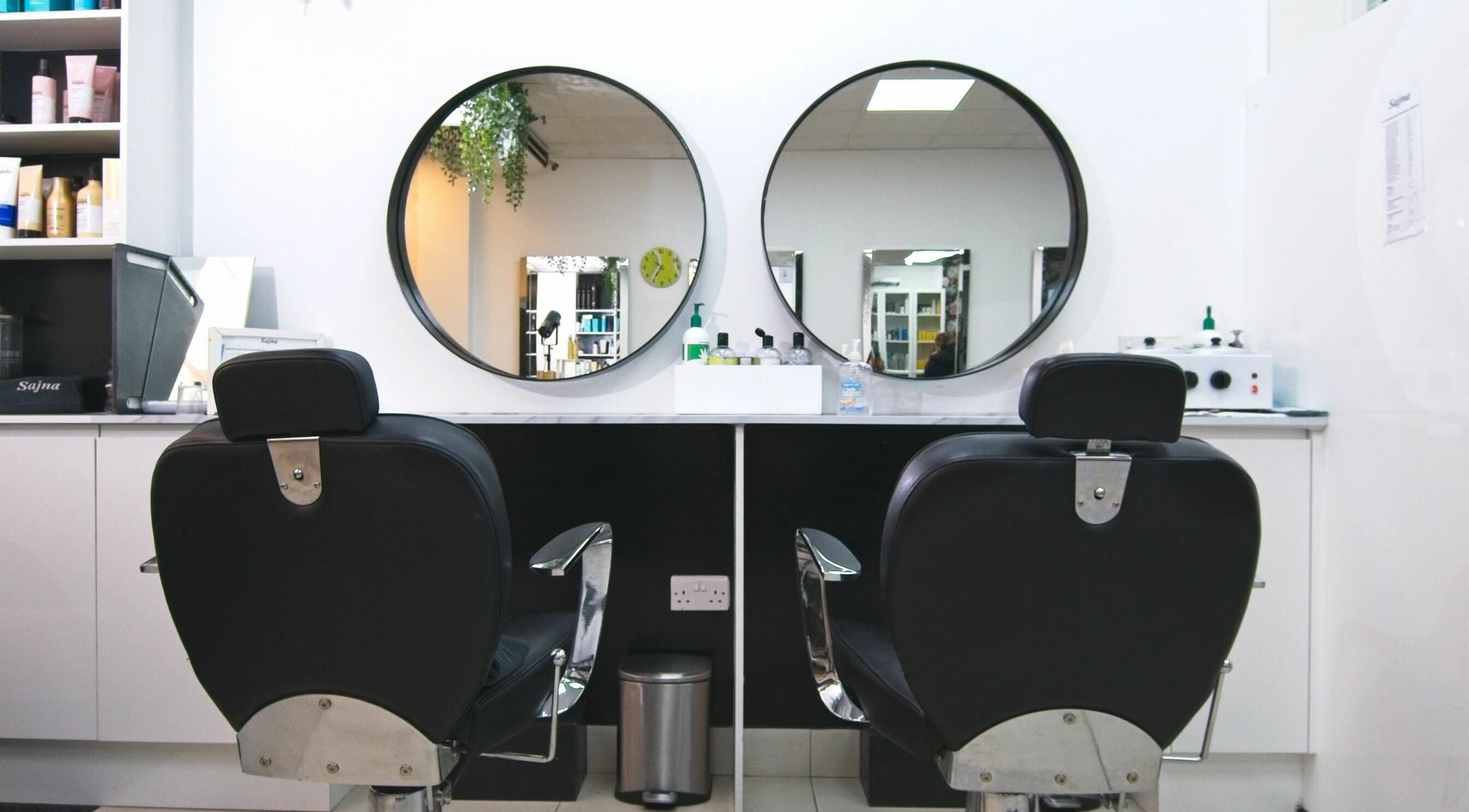 Elegant salon chairs and mirrors at Sajna Hair & Beauty, Wimbledon, London, England, GB.