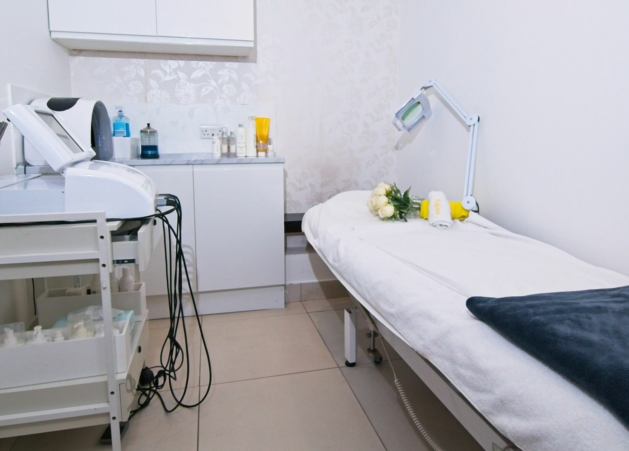 Treatment room at Sajna Hair & Beauty, Wimbledon, London, England, GB featuring a cozy bed and modern equipment.