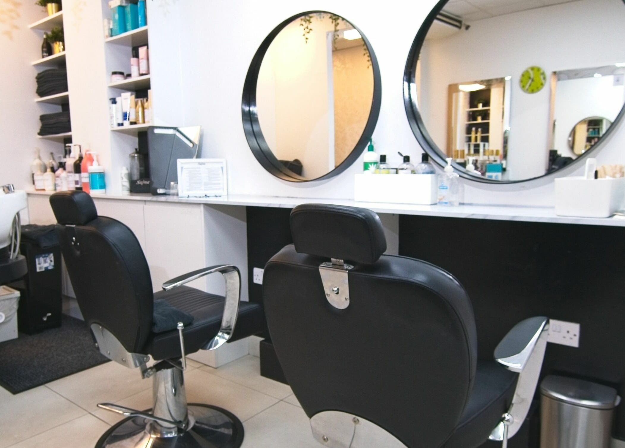 Modern salon chair and mirrors at Sajna Hair & Beauty, Wimbledon in London, England, GB for chic styling.