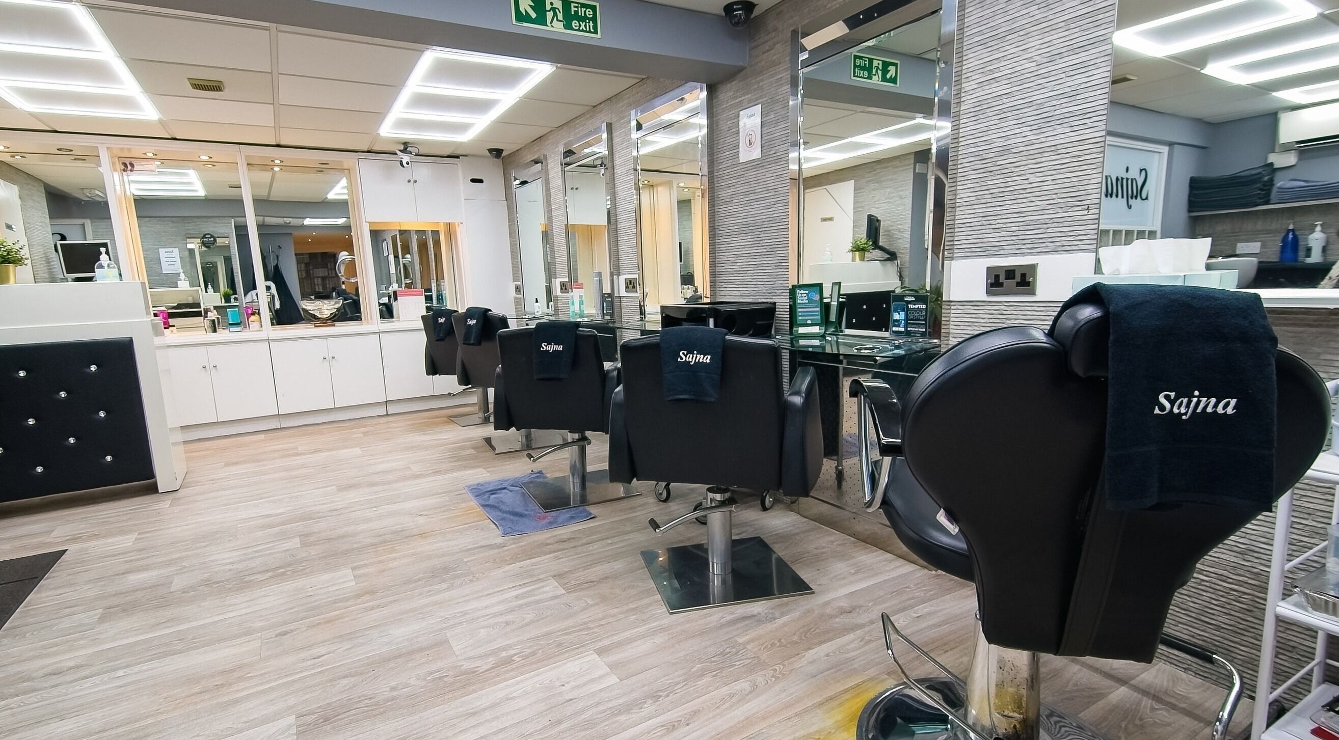 Interior of Sajna Hair and Beauty Ladies Only - Tooting, showcasing sleek styling chairs in London, England, GB.