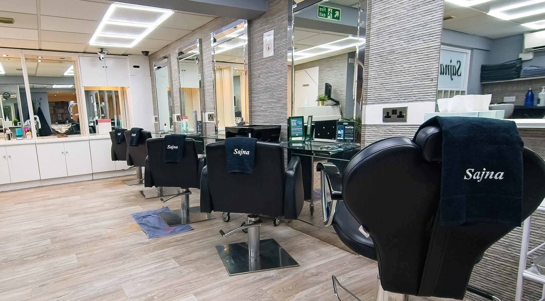 Modern salon interior at Sajna Hair and Beauty 234A Upper Tooting, London, England, GB with stylish chairs.