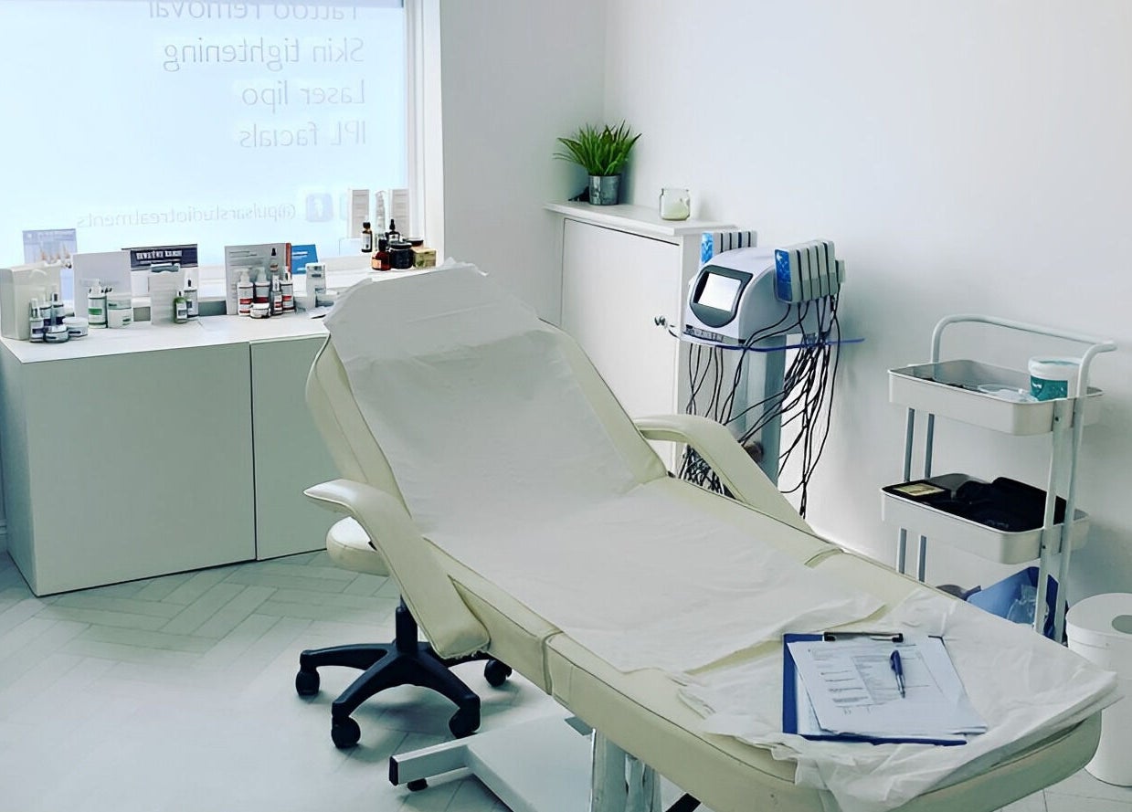 Modern treatment room at Pulsar Laser Studio, Bolton, England, GB, featuring a reclined chair and advanced equipment.