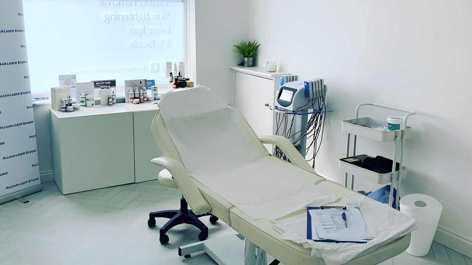 Modern treatment room at Pulsar Laser Studio, Bolton, England, GB, featuring a reclined chair and advanced equipment.
