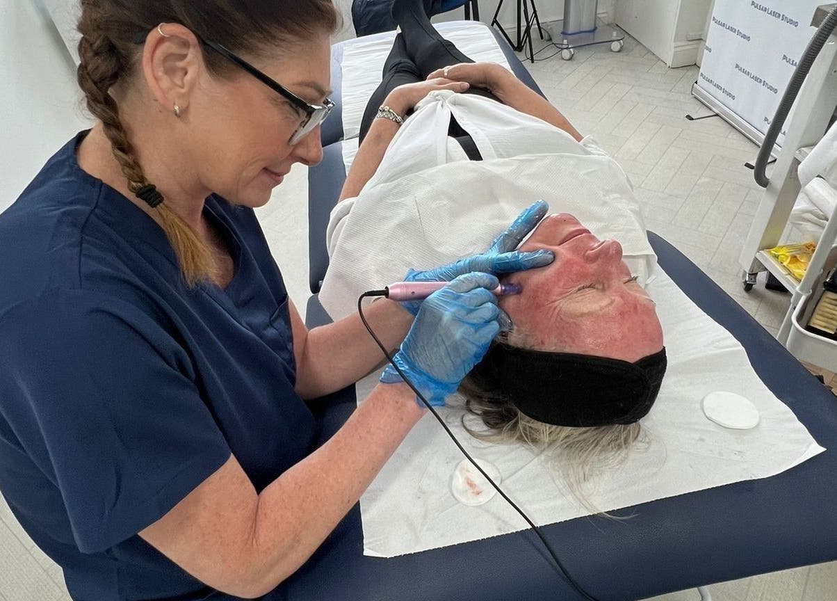 Specialist performs laser facial at Pulsar Laser Chorley, England. Relaxing and rejuvenating skincare service.