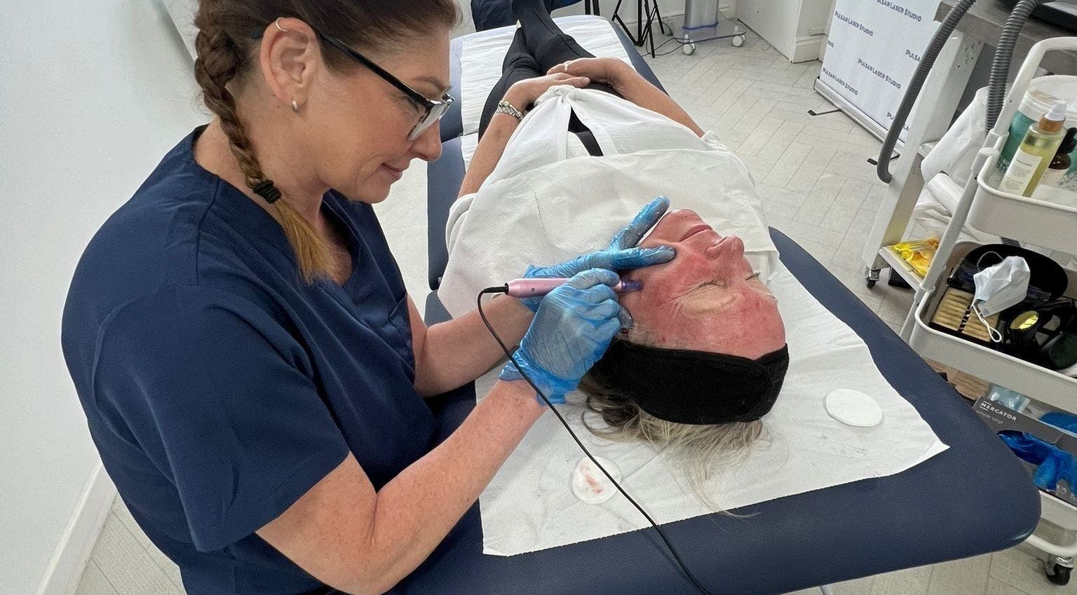 Specialist performs laser facial at Pulsar Laser Chorley, England. Relaxing and rejuvenating skincare service.