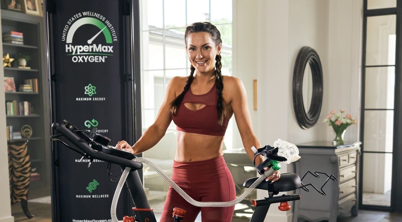 Woman using oxygen therapy at Alfred's Wellness bike room, Willowbrook, Illinois, US for energy boost.