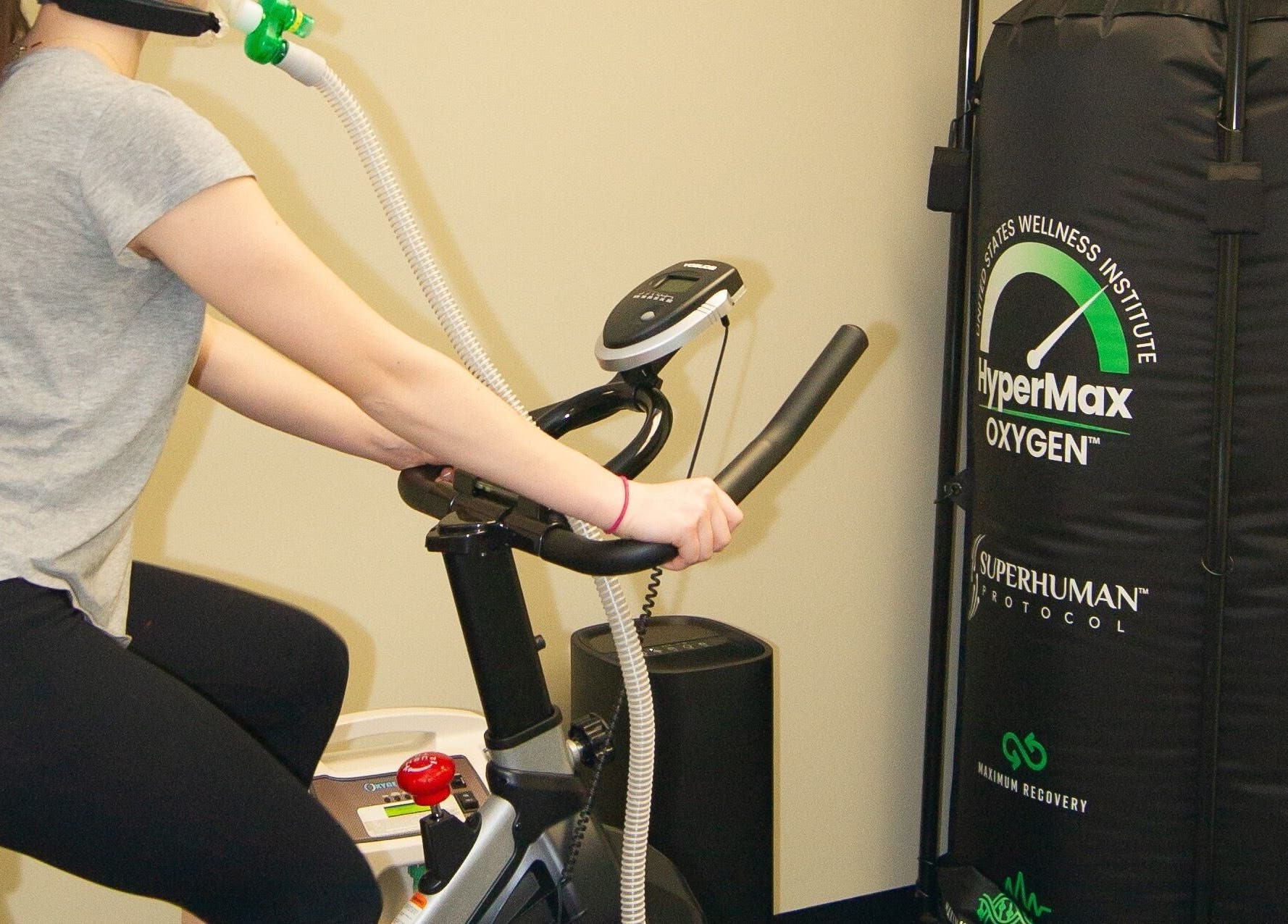 A person exercises on a bike with HyperMax mask at Alfred's Wellness, Willowbrook, Illinois, US.