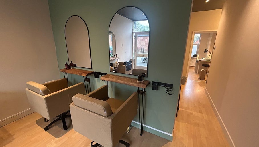 Chic interior of The Salon At Twenty Four, Woodford Halse, England, GB with two stylish salon chairs.