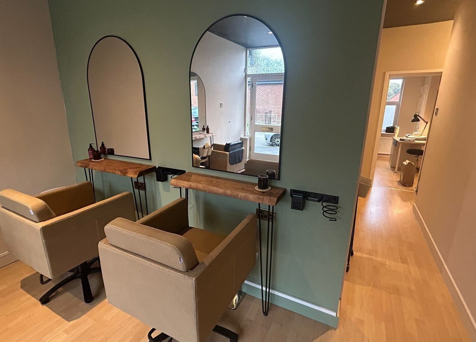 Chic interior of The Salon At Twenty Four, Woodford Halse, England, GB with two stylish salon chairs.
