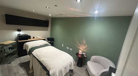 Relaxing spa room at The Salon At Twenty Four in Woodford Halse, England, GB with soft lighting and cozy treatment bed.