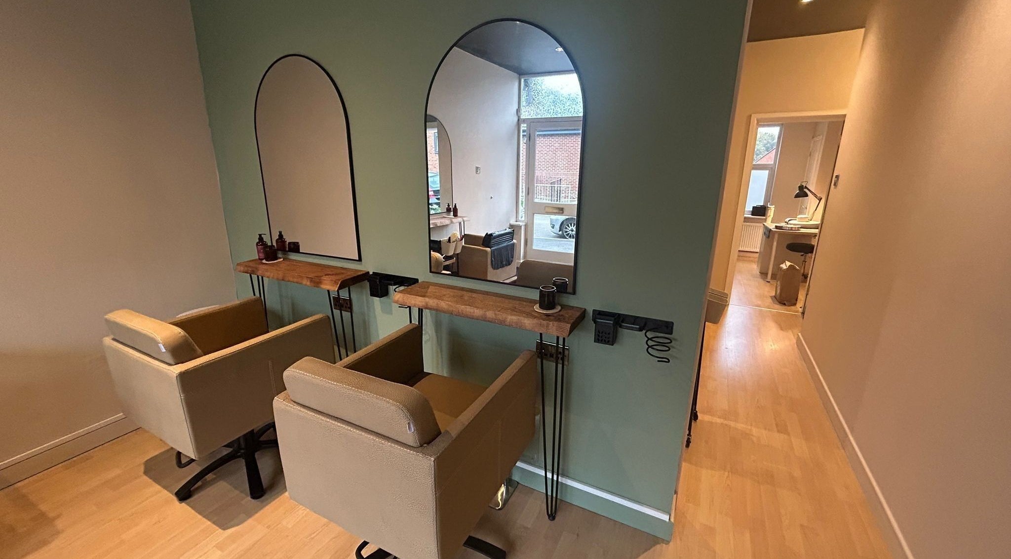 Chic styling station at The Salon At Twenty Four, Woodford Halse, England, GB, featuring mirrors and chairs.