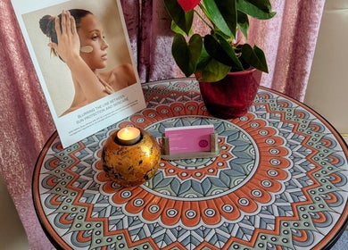 Intricate table decor at Vanity Fair Beauty & Skin Care Salon in Auckland, NZ featuring a candle and plant.