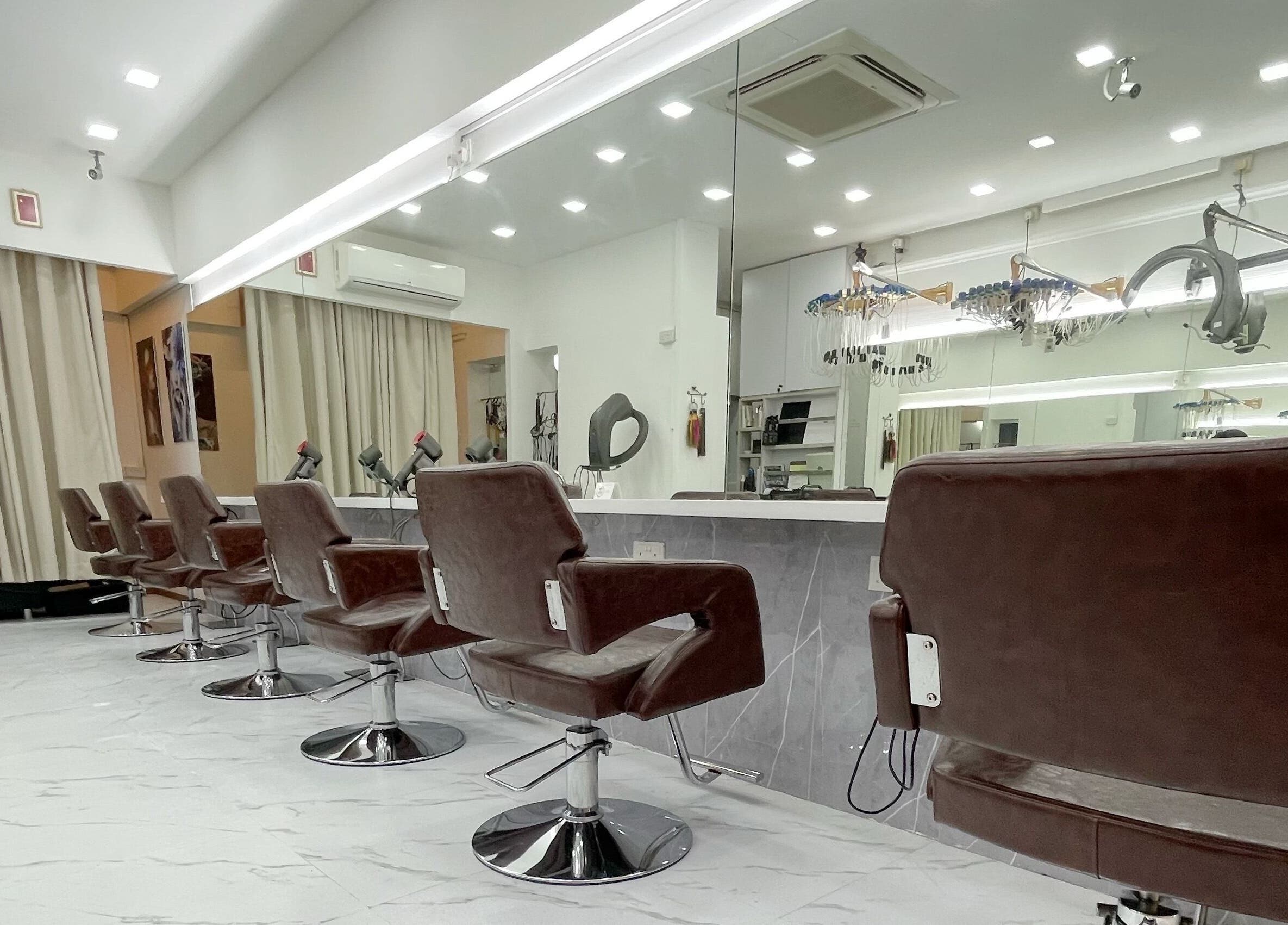 Modern interior of HAVA Hair with chic brown salon chairs in Complex, SG, reflecting luxury and style.