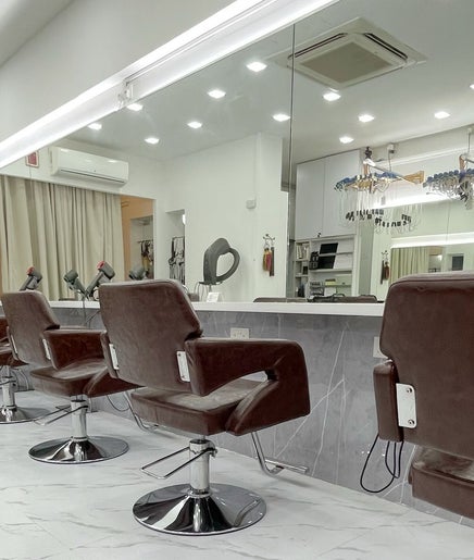 Modern interior of HAVA Hair with chic brown salon chairs in Complex, SG, reflecting luxury and style.