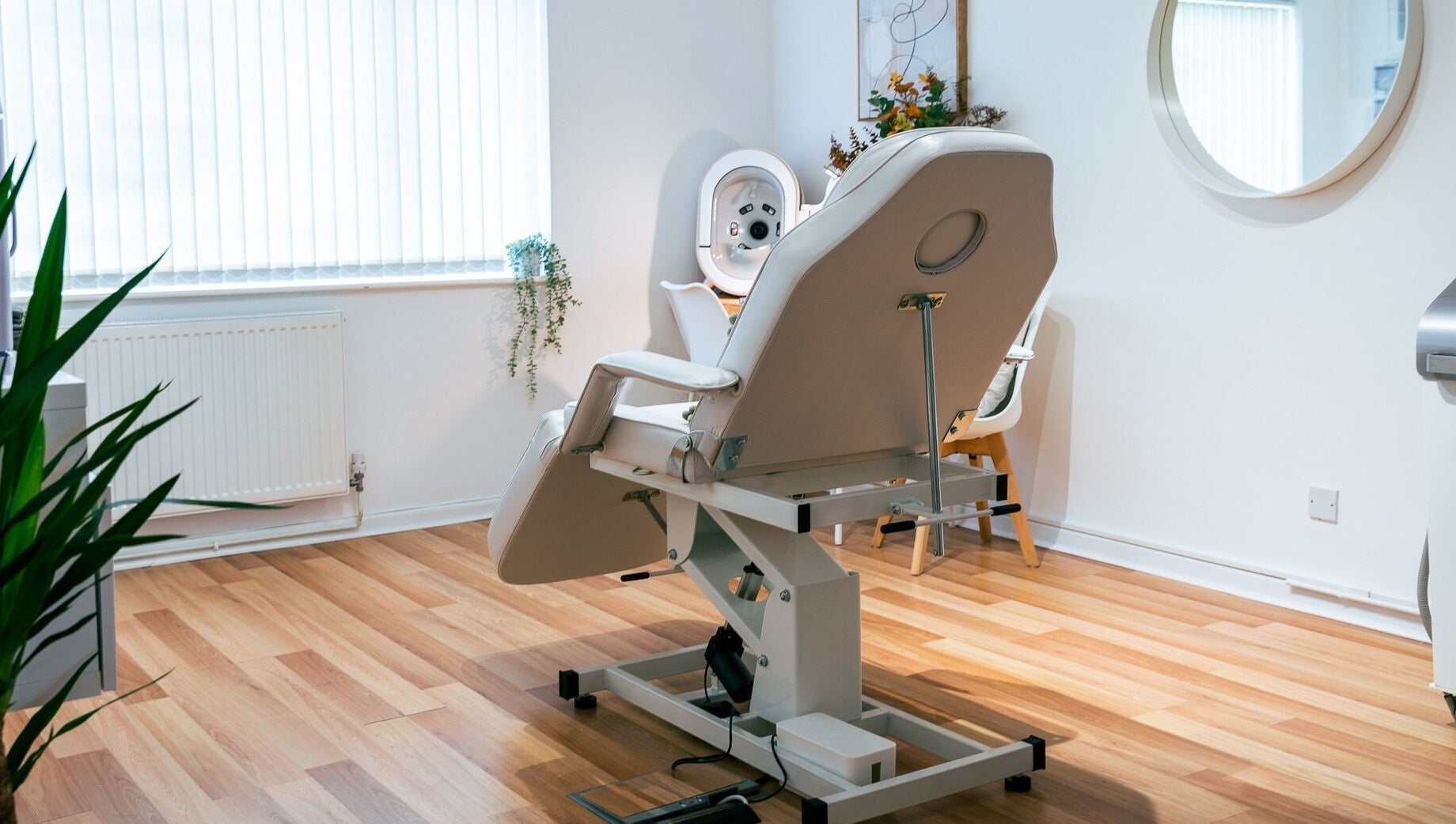 A serene treatment room at Gower Skin Aesthetics, Kittle, Wales, GB featuring a modern adjustable chair.