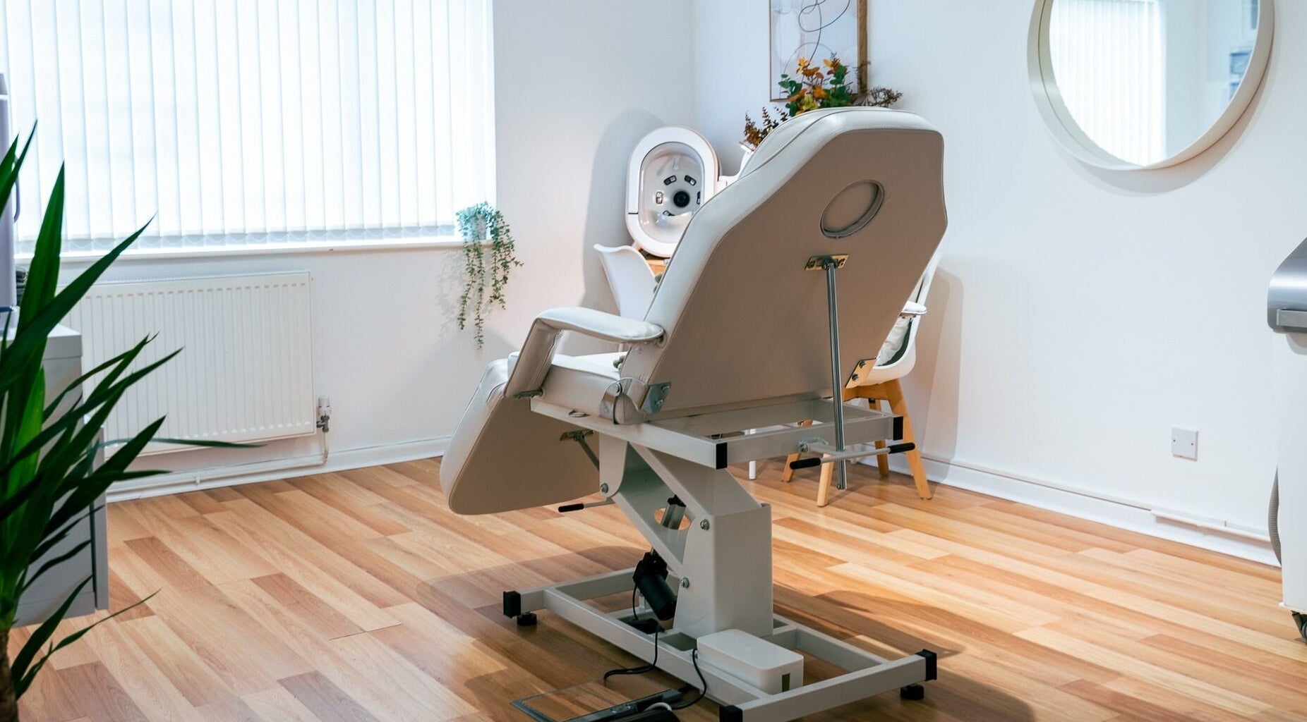 A serene treatment room at Gower Skin Aesthetics, Kittle, Wales, GB featuring a modern adjustable chair.