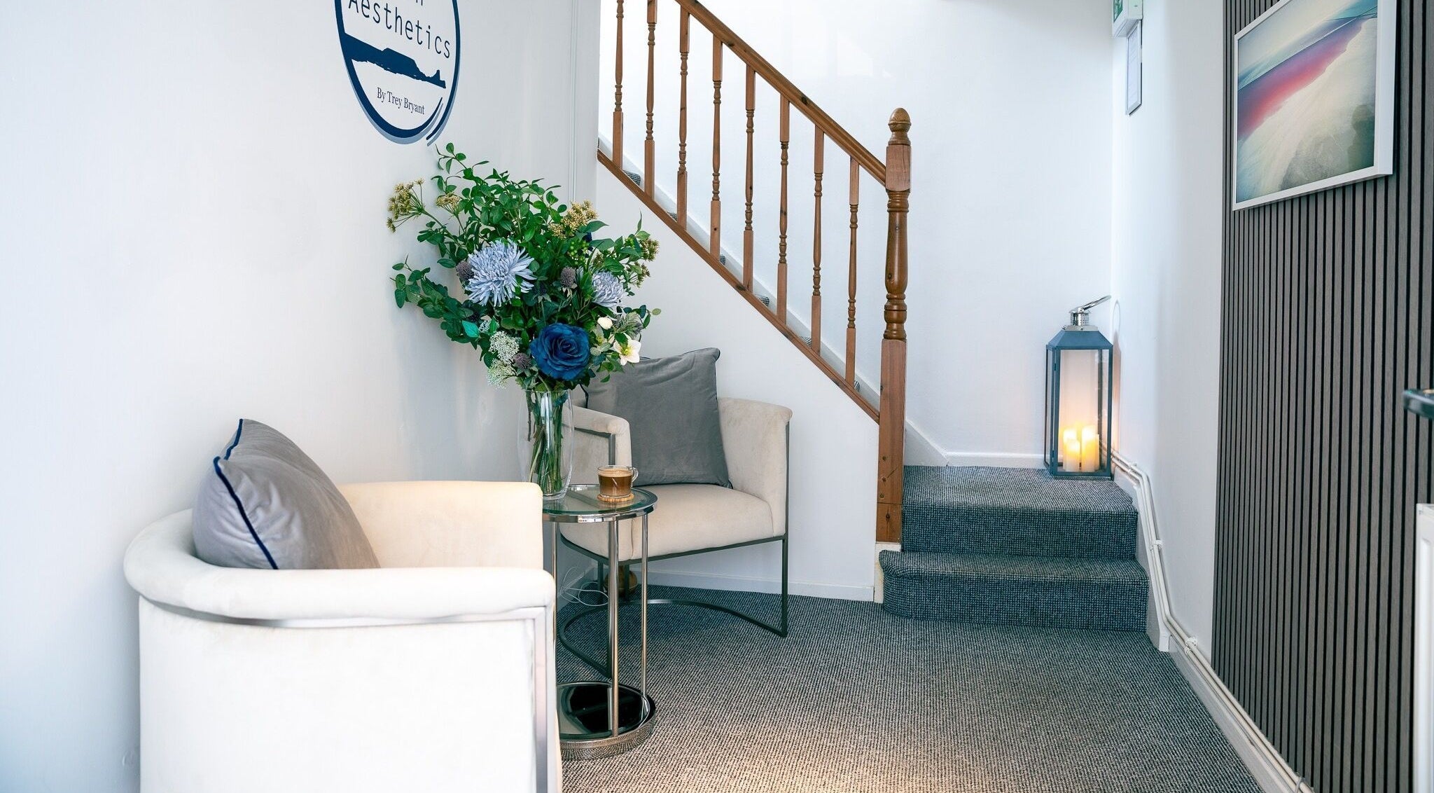 Elegant waiting area at Gower Skin Aesthetics, Kittle, Wales, GB with plush chair and floral decor.