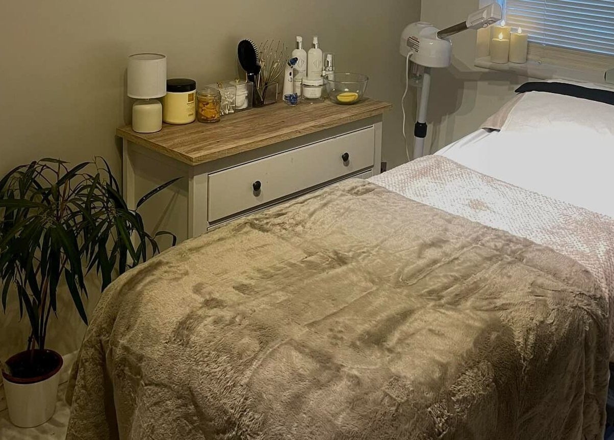Cozy treatment room at Gower Skin Aesthetics, Kittle, Wales, GB featuring a plush bed and soothing decor.