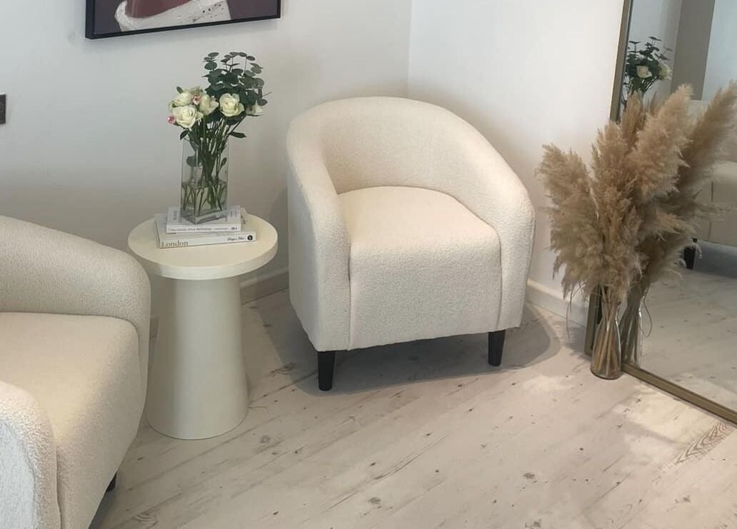 Cozy seating area at Gower Skin Aesthetics, Kittle, Wales, GB with soft chairs and elegant décor.