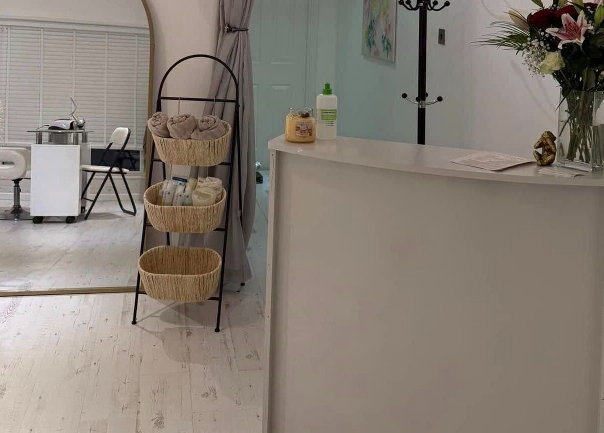 Elegant reception at Gower Skin Aesthetics, Kittle, Wales, GB with fresh flowers and cozy decor.