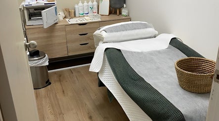 Tranquil treatment room at Eco Salon Day Spa, Bermagui, New South Wales, AU, featuring a cozy bed and calming decor.