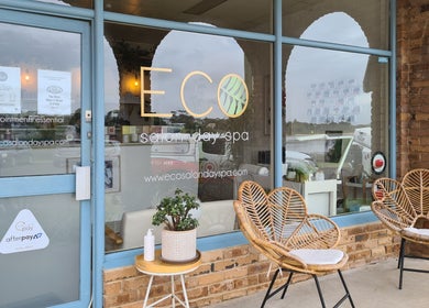Welcome to Eco Salon Day Spa in Bermagui, New South Wales, AU, featuring inviting wicker chairs and serene decor.