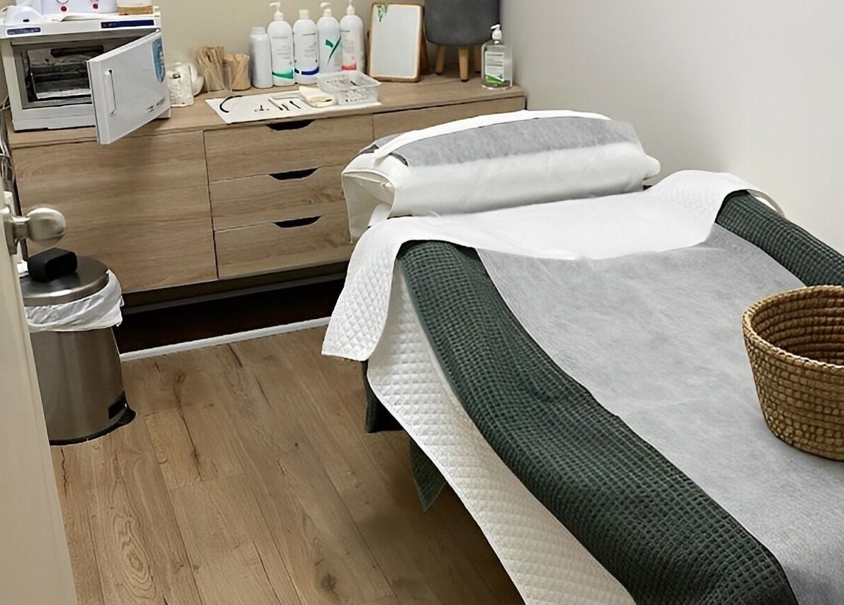 Tranquil treatment room at Eco Salon Day Spa in Bermagui, New South Wales, AU, featuring a treatment table.