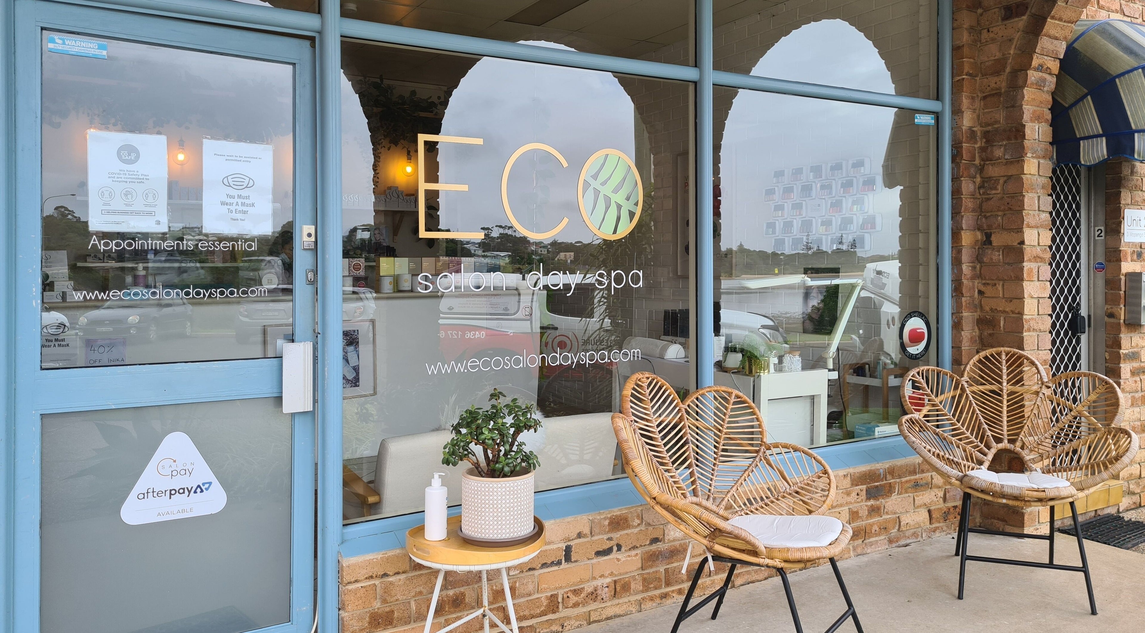 Exterior of Eco Salon Day Spa with inviting seating in Bermagui, New South Wales, AU.