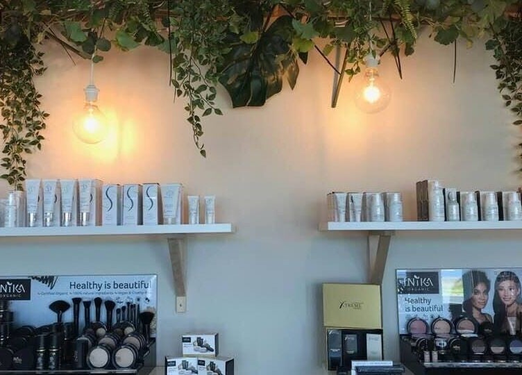Eco Salon Day Spa displays beauty products under lush greenery in Bermagui, New South Wales, AU.