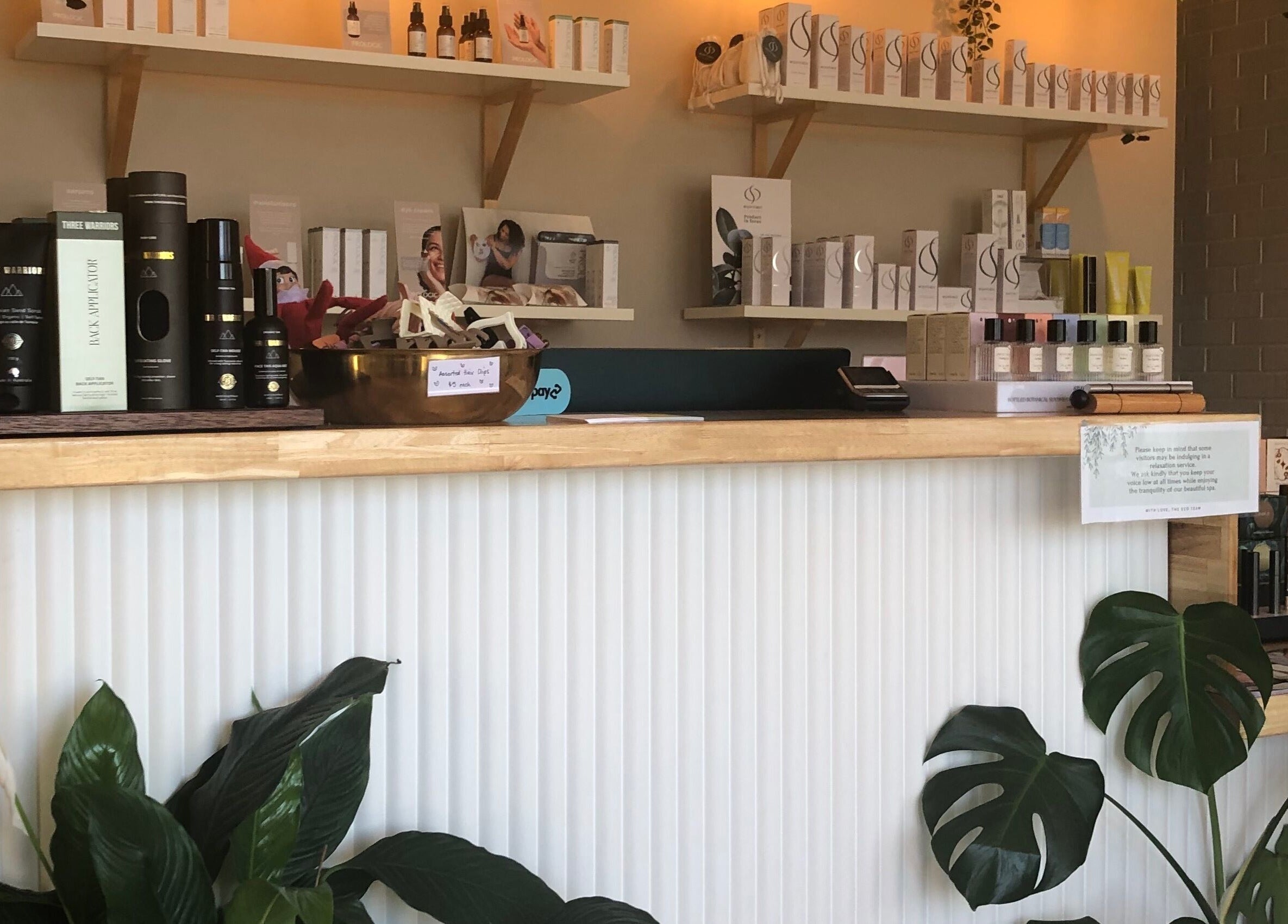 Reception area at Eco Salon Day Spa in Bermagui, New South Wales, AU showcasing beauty products.