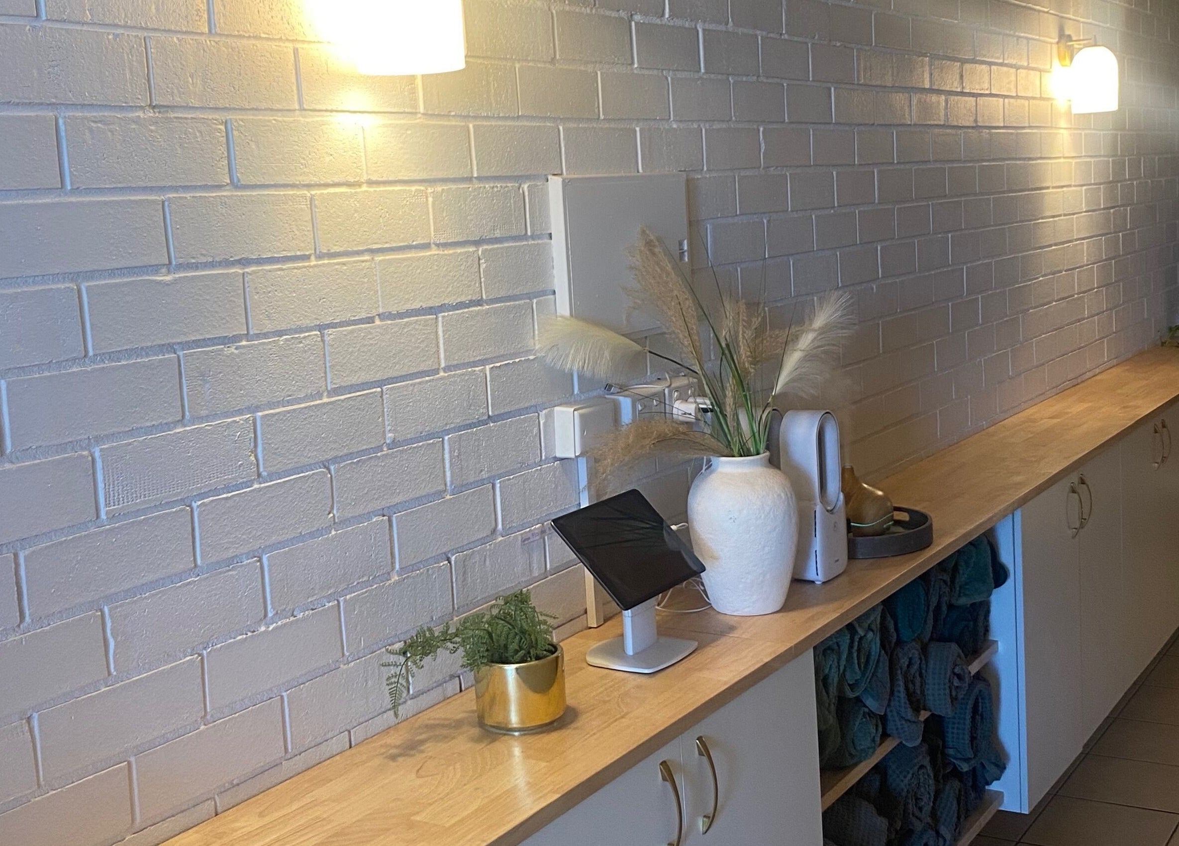 Elegant countertop at Eco Salon Day Spa, Bermagui, New South Wales, AU, adorned with plants and soft lighting.