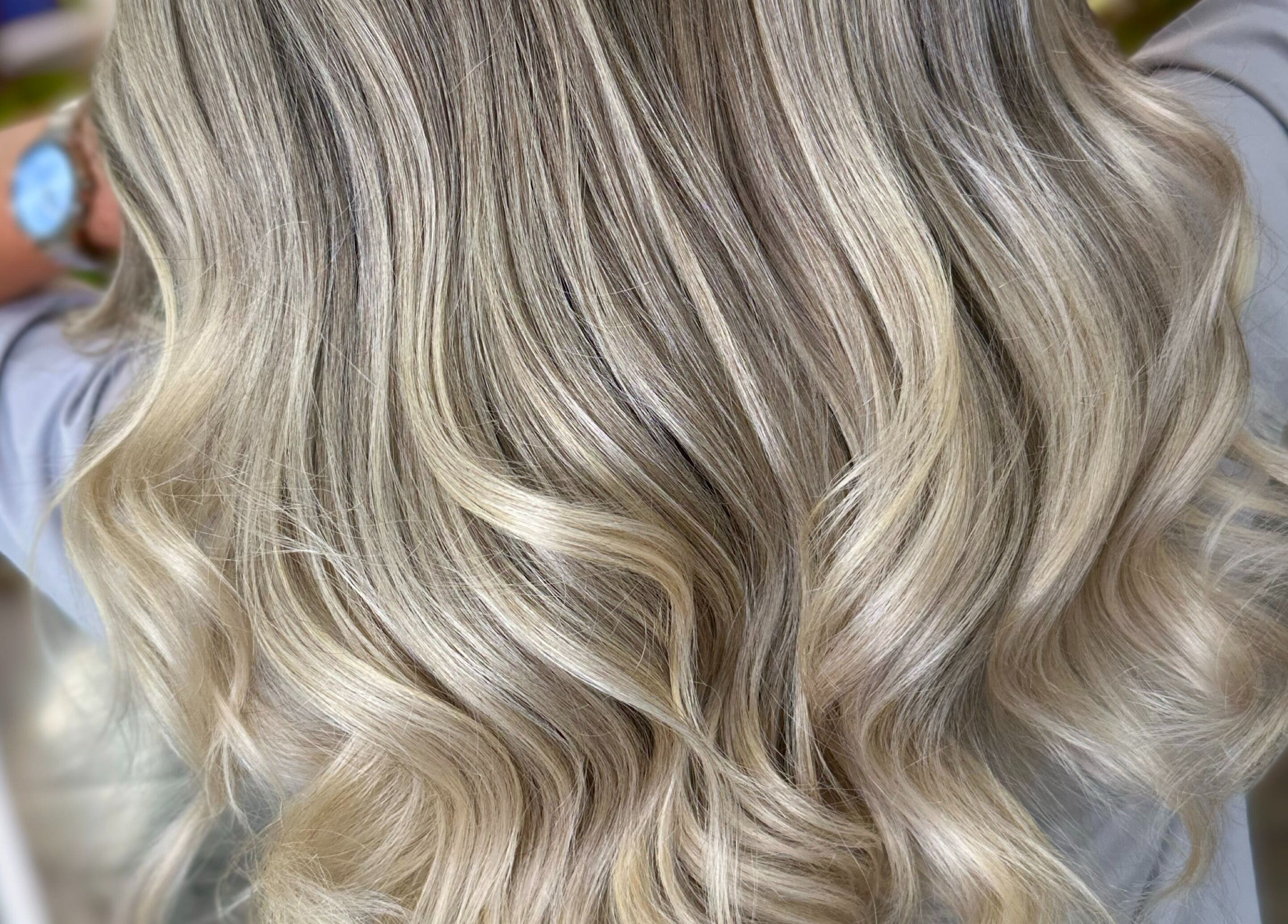 Elegant blonde waves styled at SBI SALON in Englishtown, New Jersey, US. Perfect for a luxurious look.