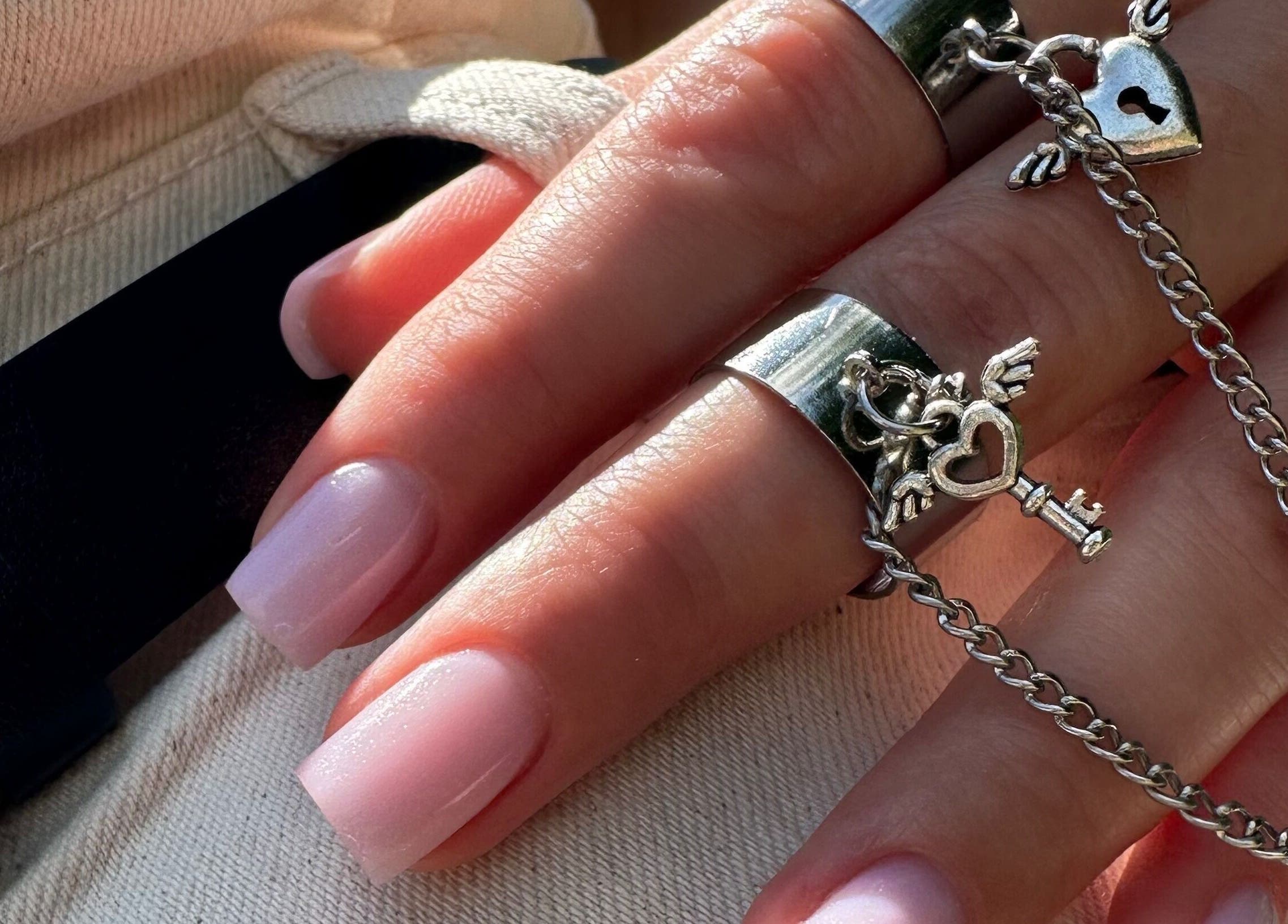 Close-up of manicured nails with silver rings at SBI SALON, Englishtown, New Jersey, US.