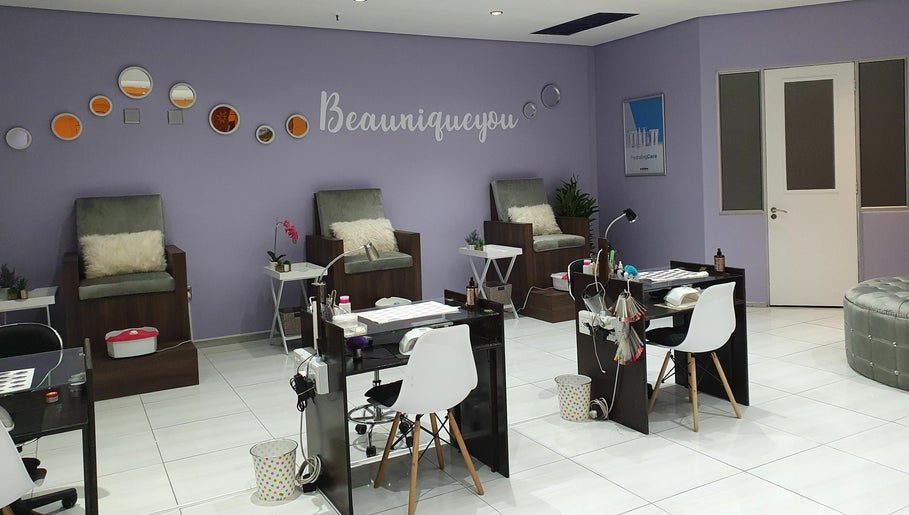 Inside Beaunique Beauty Studio Casino offering plush chairs and nail stations in Welkom, Free State, ZA.