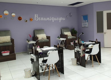 Inside Beaunique Beauty Studio Casino offering plush chairs and nail stations in Welkom, Free State, ZA.