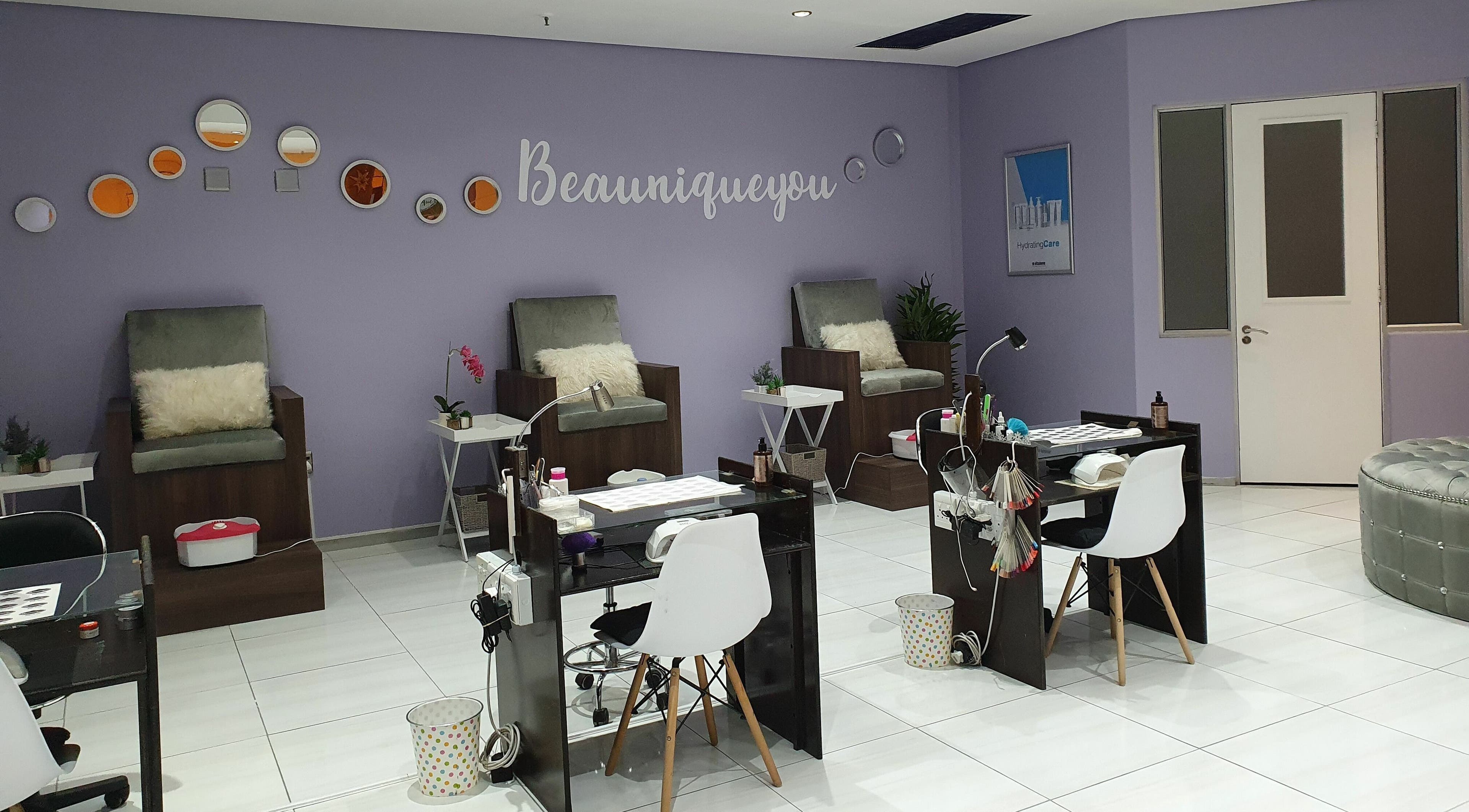 Inside Beaunique Beauty Studio Casino offering plush chairs and nail stations in Welkom, Free State, ZA.