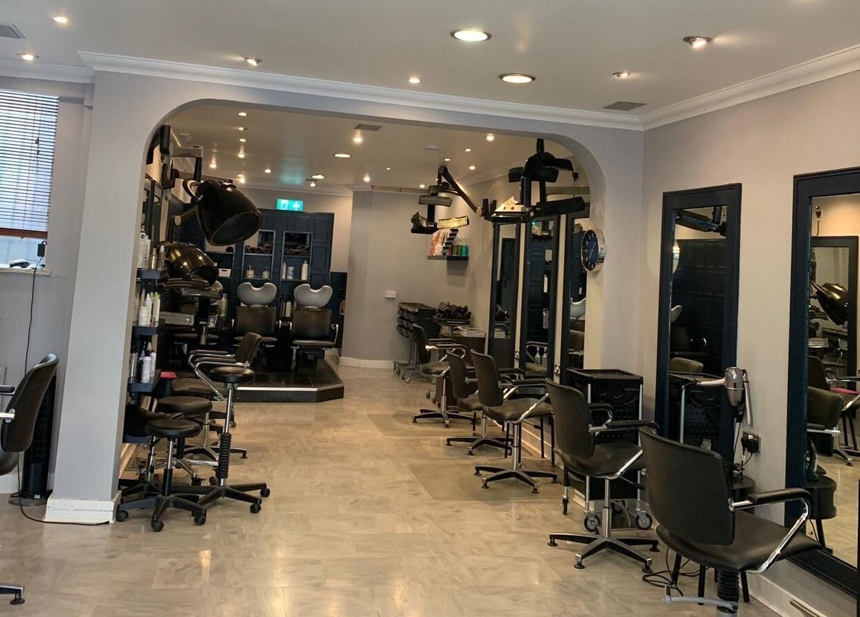 Chic interior of Ethos Blackpool, a beauty salon in Blackpool, England, GB, featuring stylish salon chairs and mirrors.