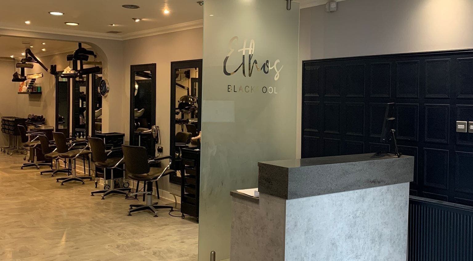 Modern salon interior at Ethos Blackpool, Blackpool, England, GB featuring stylist chairs and mirrors.