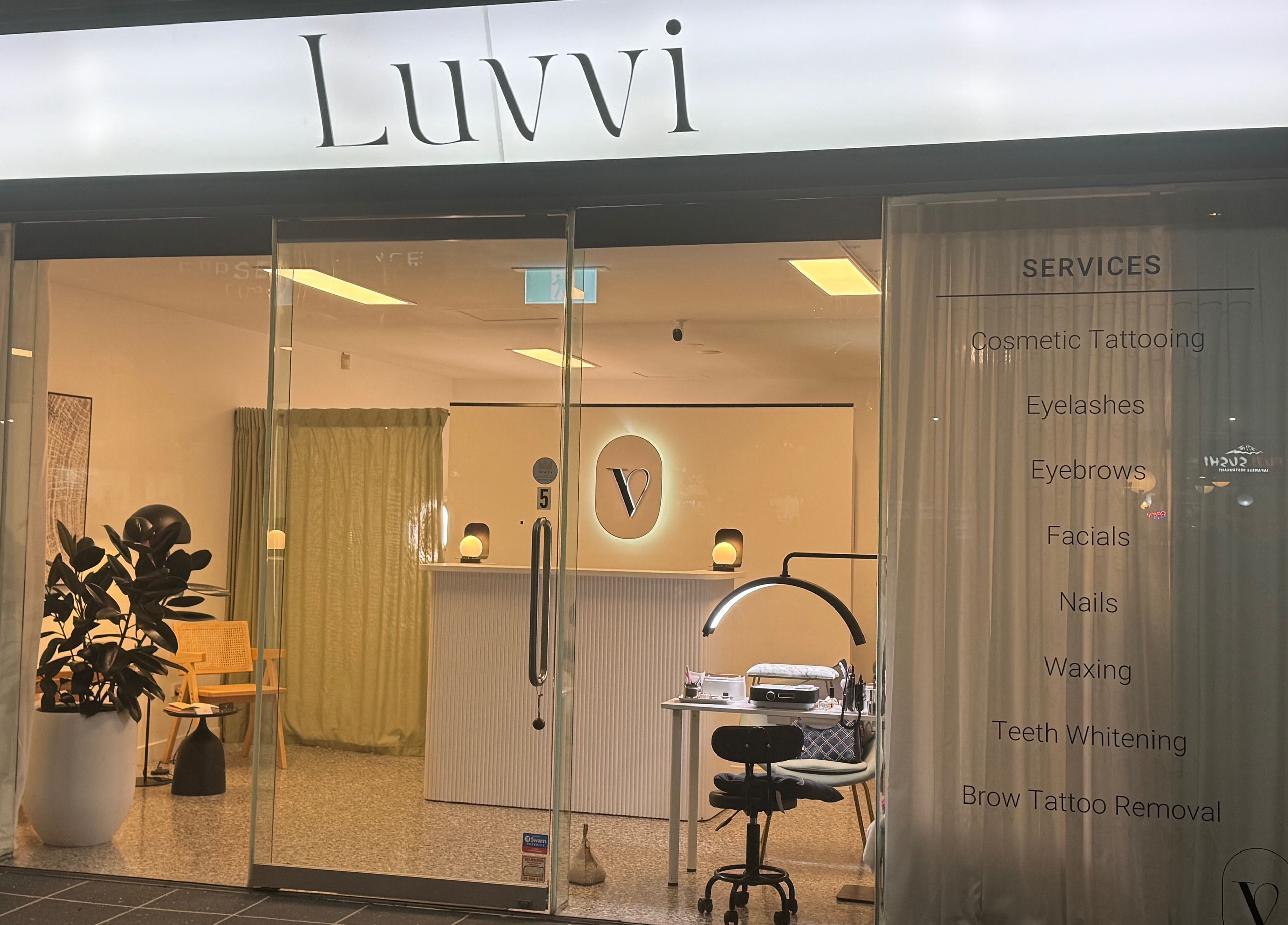 Entrance to Luvvi beauty venue in Surfers Paradise, Queensland, AU, showcasing services and modern decor.