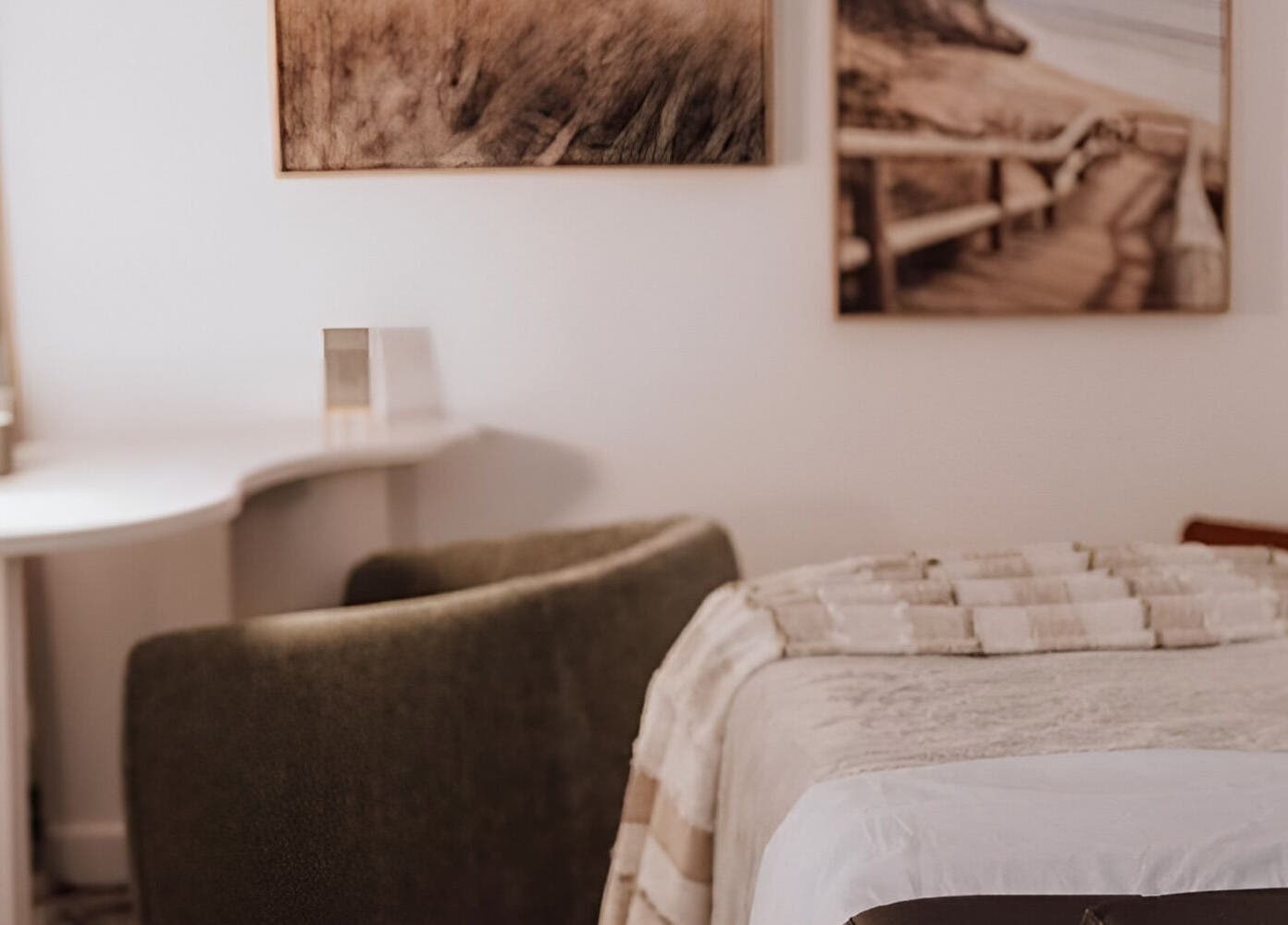 Relaxing spa room at Luvvi, Surfers Paradise, Queensland, AU, featuring a plush armchair and massage bed.