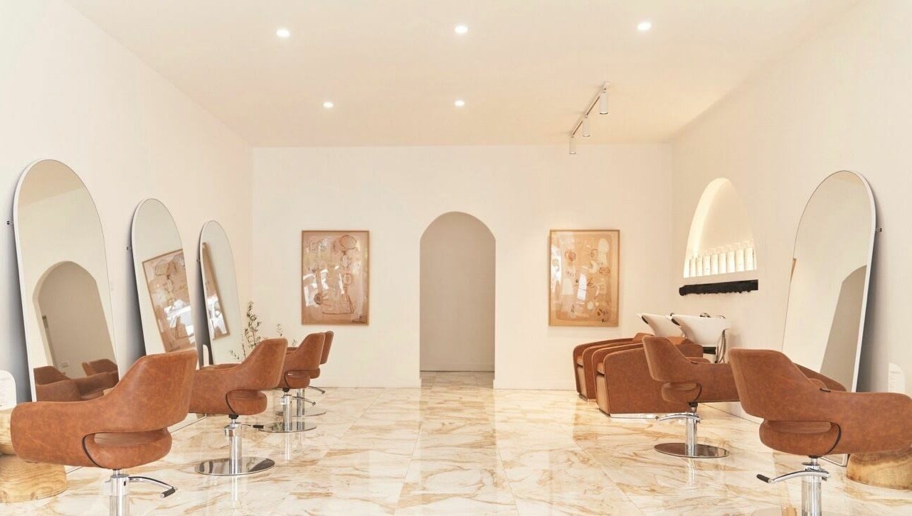 Chic interior of Blondie Bar Salon in Melbourne, Victoria, AU featuring modern chairs and large mirrors.