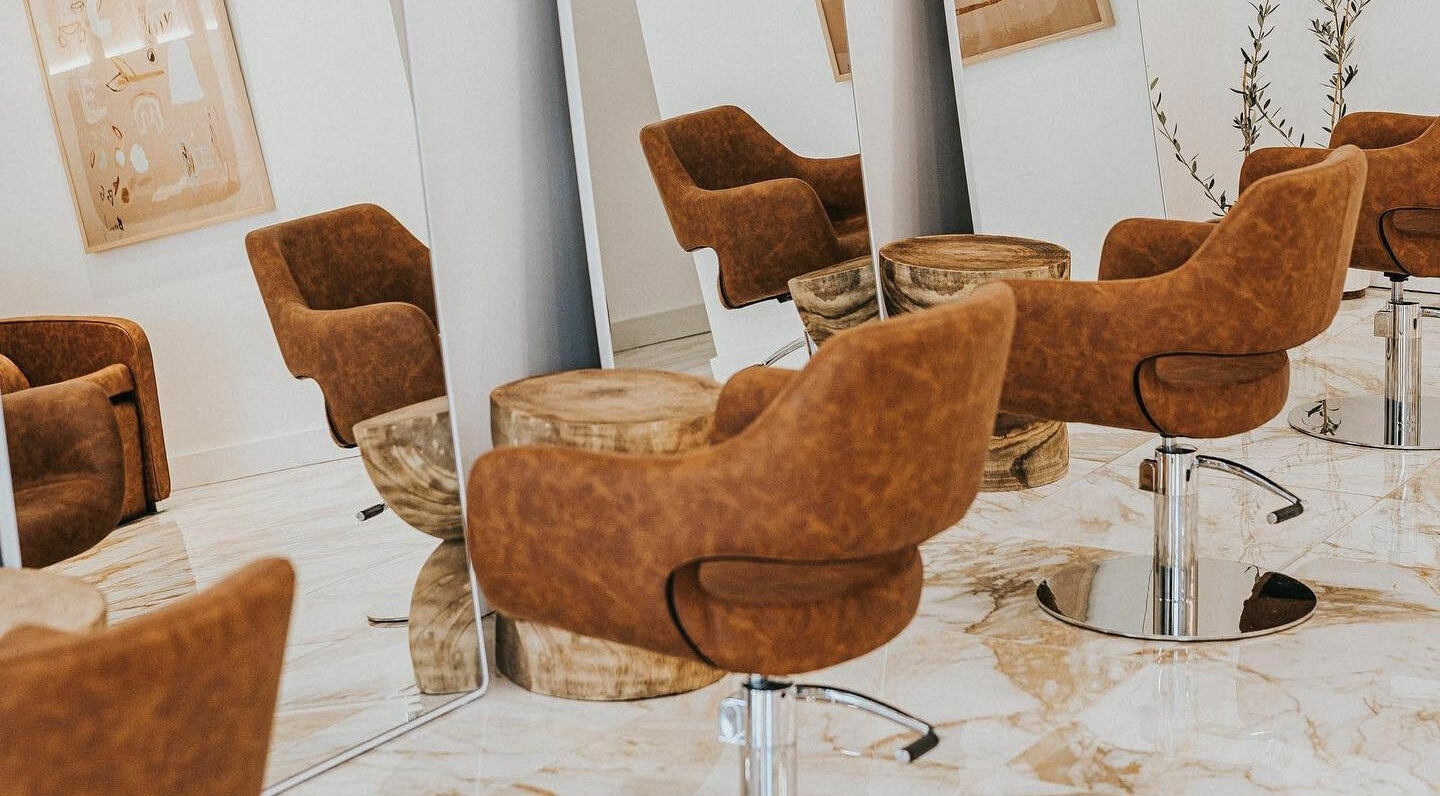 Sleek interior of Blondie Bar Salon in Melbourne, Victoria, AU with stylish brown chairs and mirrors.