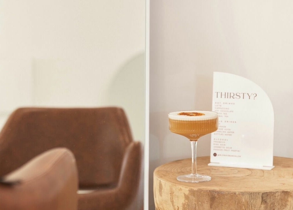 Chic seating and drink at Blondie Bar Salon, Melbourne, Victoria, AU offering refined relaxation.