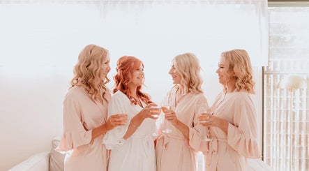 Bridesmaids celebrate at Tahnee Anderson MUA, Redbank Plains, Queensland, AU, toasting with champagne.